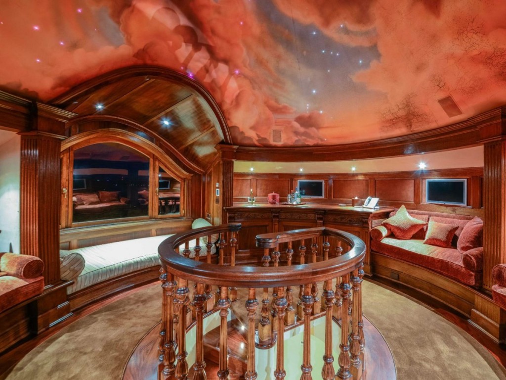 at-the-very-top-of-the-house-is-this-round-reading-room-with-a-painted-ceiling