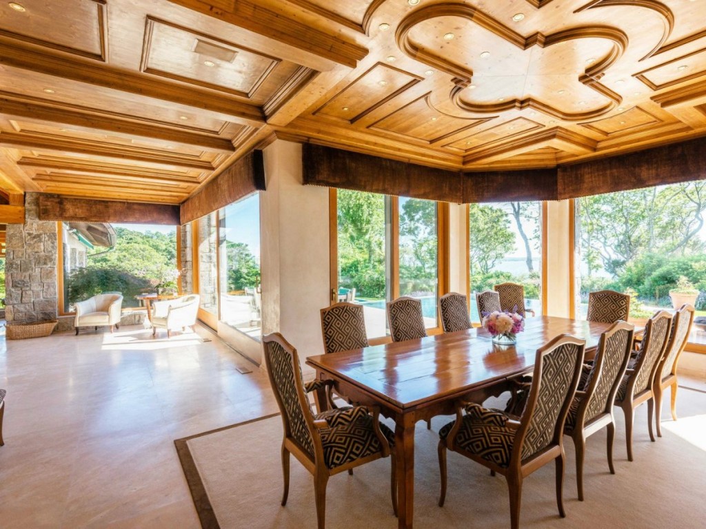 theres-also-another-room-with-an-eight-seat-dining-room-table-under-an-elaborate-wood-work-ceiling